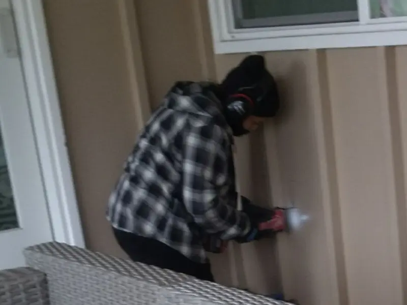 Professional electrician installing an exterior outlet in Broadway